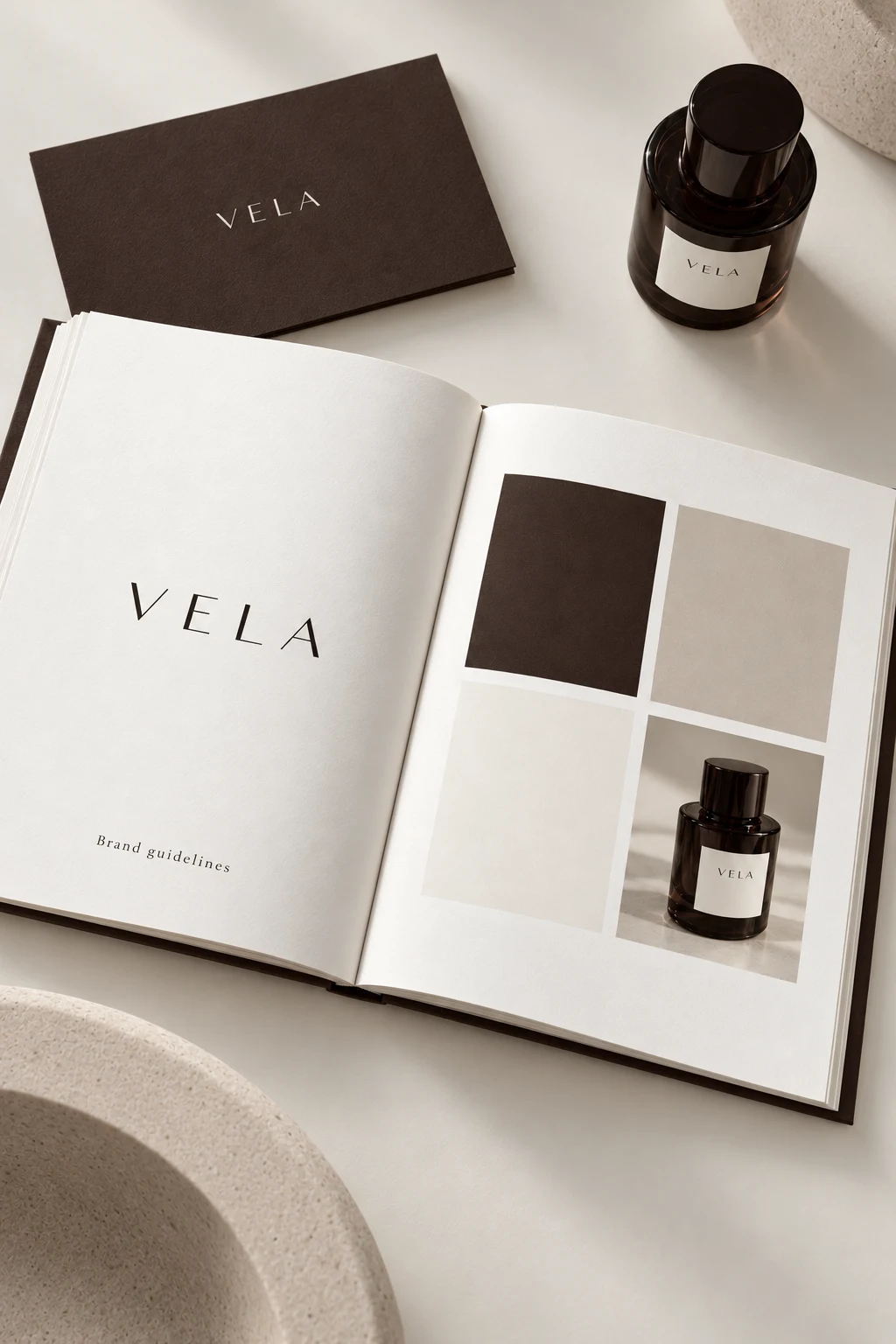 Open VELA brandbook showing a spaced wordmark, warm color swatches and a espresso skincare bottle photograph