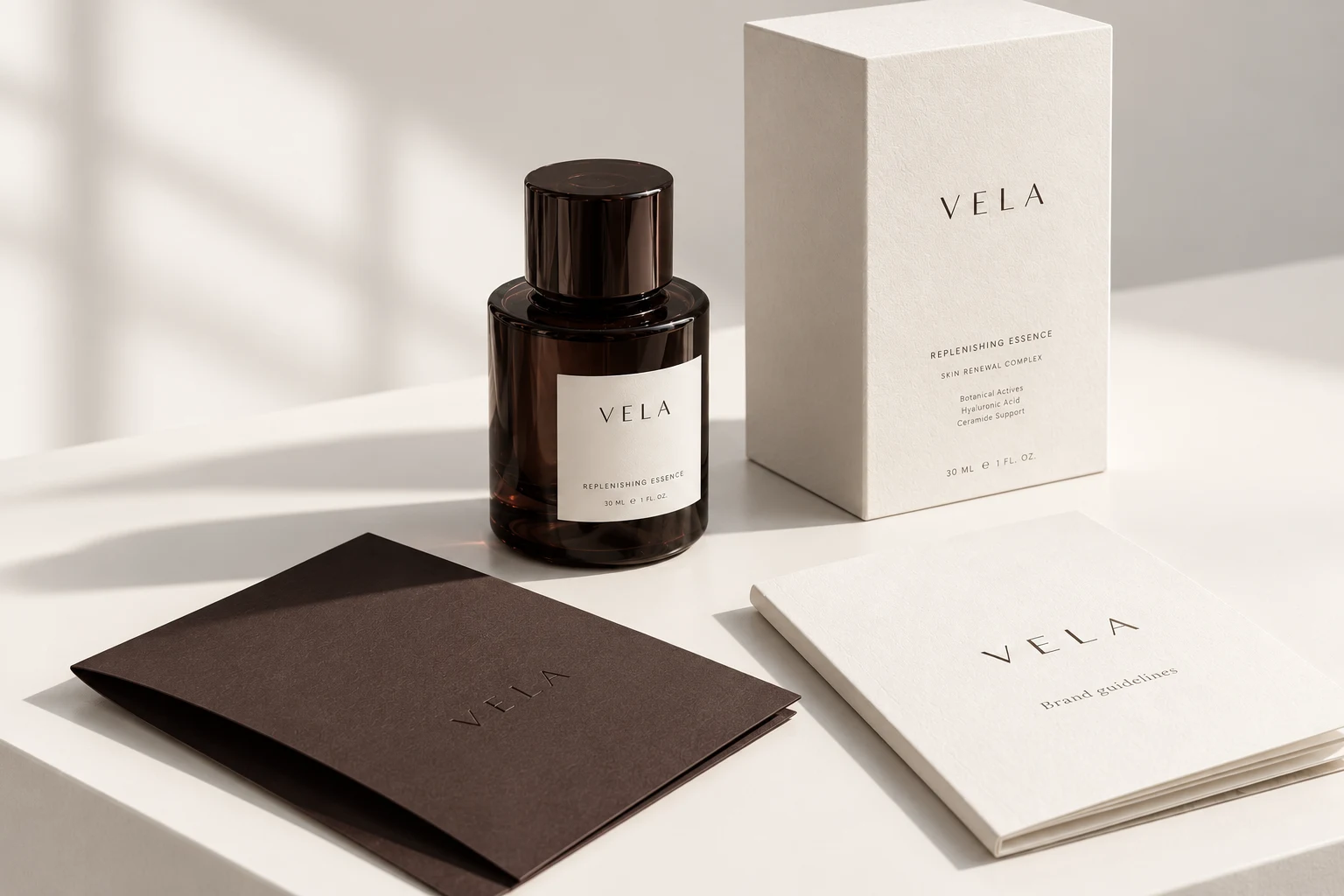 VELA skincare concept: espresso glass and ivory packaging on a pale studio surface